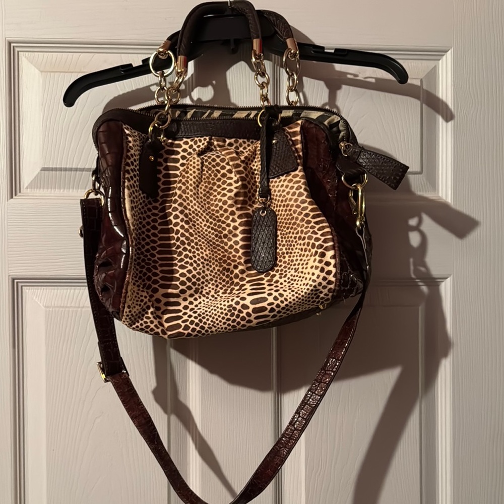 This bag is well loved. Fur has been rubbed away in places due to wear.